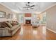 Inviting living room featuring hardwood floors, a fireplace, and ample natural light at 115 Dearing Woods Way, Covington, GA 30014