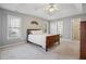 Serene main bedroom featuring a tray ceiling, neutral paint, and lots of natural light at 115 Dearing Woods Way, Covington, GA 30014