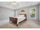 Serene main bedroom featuring a tray ceiling, neutral paint, and lots of natural light at 115 Dearing Woods Way, Covington, GA 30014