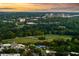 Expansive aerial view of a community featuring a pool, sports fields, and verdant green spaces within a city setting at 31 Lafayette Ne Dr, Atlanta, GA 30309