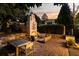 A stunning backyard featuring an outdoor fireplace, wooden seating, and city views at 31 Lafayette Ne Dr, Atlanta, GA 30309