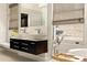 Bathroom featuring double sink vanity and bathtub; large windows provide natural light at 31 Lafayette Ne Dr, Atlanta, GA 30309