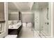 Bright bathroom featuring double sinks, a soaking tub, and a glass-enclosed shower with marble accents at 31 Lafayette Ne Dr, Atlanta, GA 30309
