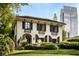 Elegant stucco home features dark shutters, manicured landscaping, and a beautiful lawn at 31 Lafayette Ne Dr, Atlanta, GA 30309