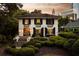 Elegant two-story home features dark shutters, manicured landscaping, and a inviting entrance at 31 Lafayette Ne Dr, Atlanta, GA 30309