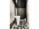 Stylish powder room featuring a modern pedestal sink, elegant mirror, and patterned floor tiles at 31 Lafayette Ne Dr, Atlanta, GA 30309