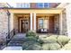 Inviting front porch with stone columns and a cozy seating area at 5352 Lacosta Ln, Alpharetta, GA 30022