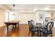 Large game room features a pool table and dining table with modern lighting at 5352 Lacosta Ln, Alpharetta, GA 30022