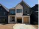 New construction shows a modern two-story home with white brick and a two-car garage at 2583 Apple Valley Rd, Brookhaven, GA 30319