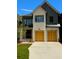 Charming two-story home featuring a mix of brick and siding, complemented by wooden garage doors at 2583 Apple Valley Rd, Brookhaven, GA 30319