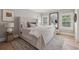 Well-lit main bedroom features a comfortable bed, two windows and a large mirror at 2583 Apple Valley Rd, Brookhaven, GA 30319