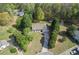 Expansive aerial view of a charming ranch home with a long drive and lush green trees at 313 Ridge Hill Cir, Canton, GA 30115