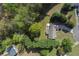 An aerial view of a home with a lush green yard, mature trees, and a long driveway leading to the street at 313 Ridge Hill Cir, Canton, GA 30115