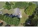 Aerial view of a charming single-story home with a large lot, fenced yard and mature trees at 313 Ridge Hill Cir, Canton, GA 30115
