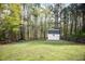 Picturesque backyard featuring an outbuilding and wooded area at 313 Ridge Hill Cir, Canton, GA 30115