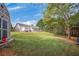Expansive backyard featuring lush green grass, mature trees, and a storage shed at 313 Ridge Hill Cir, Canton, GA 30115