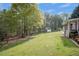 Image of the backyard with a shed, playset and mature trees at 313 Ridge Hill Cir, Canton, GA 30115