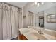 Well-lit bathroom featuring a large mirror, white shiplap walls, and a neutral-toned shower curtain at 313 Ridge Hill Cir, Canton, GA 30115