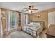 Charming bedroom with a metal bed frame, wood accent wall, and bright windows with views of the outdoors at 313 Ridge Hill Cir, Canton, GA 30115