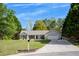 Well-maintained single-story home featuring a manicured lawn, neutral siding, and an attached garage at 313 Ridge Hill Cir, Canton, GA 30115