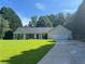Charming single-story home with a well-manicured lawn and an attached two-car garage at 313 Ridge Hill Cir, Canton, GA 30115