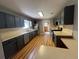Galley kitchen featuring stainless steel appliances, painted cabinets, and wood-look floors at 313 Ridge Hill Cir, Canton, GA 30115