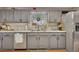 Charming kitchen with gray cabinets, stainless steel appliances, and ample counter space at 313 Ridge Hill Cir, Canton, GA 30115