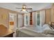 Serene main bedroom with natural light, a ceiling fan, and en-suite bath at 313 Ridge Hill Cir, Canton, GA 30115