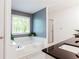 Bright bathroom featuring a large tub, walk in shower and dual sinks at 3612 Tree View Dr, Snellville, GA 30078