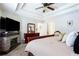 Spacious bedroom boasts a tray ceiling, stone fireplace, and plush carpeting at 3612 Tree View Dr, Snellville, GA 30078