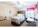 Comfortable bedroom with a large bed, glass top desk, and lots of natural light at 3612 Tree View Dr, Snellville, GA 30078