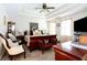A main bedroom with a tray ceiling, ceiling fan, and dark wood furniture at 3612 Tree View Dr, Snellville, GA 30078