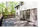 Back deck area featuring gray wood planks, black railing, windows, and white siding at 3612 Tree View Dr, Snellville, GA 30078