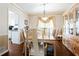 Classic dining room with a wooden table, ornate chandelier, and elegant decor at 3612 Tree View Dr, Snellville, GA 30078