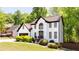 Charming two-story home with a well-manicured lawn and lush green trees at 3612 Tree View Dr, Snellville, GA 30078