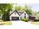 Charming two-story home with a well-manicured lawn and lush green trees at 3612 Tree View Dr, Snellville, GA 30078