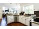 A well-lit kitchen features granite countertops, stainless steel appliances, and white cabinets at 3612 Tree View Dr, Snellville, GA 30078