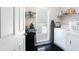 A functional laundry room with storage shelves, a window, and a washer and dryer at 3612 Tree View Dr, Snellville, GA 30078