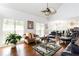 Comfortable living room featuring vaulted ceilings, large windows, and stylish furnishings at 3612 Tree View Dr, Snellville, GA 30078
