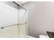 Bathroom shower featuring a glass door, metal handle, and white interior at 3612 Tree View Dr, Snellville, GA 30078
