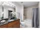 Bathroom with granite countertop vanity, shower/tub combo, and neutral tile at 855 Peachtree Ne St # 1508, Atlanta, GA 30308