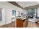 Modern kitchen with breakfast bar, stainless steel appliances, and city views from the adjacent living space at 855 Peachtree Ne St # 1508, Atlanta, GA 30308