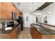 Modern kitchen with granite countertops, stainless appliances, and wood cabinets, offering a clean, efficient space at 855 Peachtree Ne St # 1508, Atlanta, GA 30308