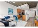 Open living space with modern decor, concrete ceiling, and seamless access to the adjacent kitchen at 855 Peachtree Ne St # 1508, Atlanta, GA 30308