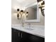 Elegant bathroom with a marble countertop, stylish lighting fixtures and black hardware at 1143 Morningside Ne Pl, Atlanta, GA 30306