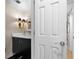 Nicely decorated half-bathroom with a black vanity, marble countertop, and modern lighting at 1143 Morningside Ne Pl, Atlanta, GA 30306