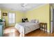 Bedroom with hardwood floors, shuttered windows, ceiling fan, desk, and natural light at 1143 Morningside Ne Pl, Atlanta, GA 30306