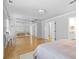 Spacious bedroom with large mirrored closet doors and hardwood floors leading to an en suite bathroom at 1143 Morningside Ne Pl, Atlanta, GA 30306