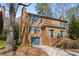 Charming brick townhome showcasing a well-manicured lawn, blue shutters, and convenient garage at 1143 Morningside Ne Pl, Atlanta, GA 30306