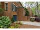 Charming brick home with a blue garage door, surrounded by mature trees and manicured landscaping at 1143 Morningside Ne Pl, Atlanta, GA 30306